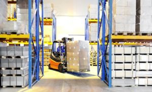 6419110-Worker-driver-of-a-forklift-loader-in-blue-workwear-at-warehouse-with-cardboard-boxes-on-pallet-Stock-Photo-300x182 6419110-Worker-driver-of-a-forklift-loader-in-blue-workwear-at-warehouse-with-cardboard-boxes-on-pallet-Stock-Photo